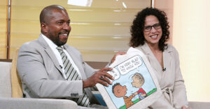Arizona Black Chamber CEO Robin Reed is presented with a Peanuts tote bag featuring Franklin and Linus after it was revealed that Reed was the voice of Franklin in a Charlie Brown Thanksgiving while VP of Corporate Partnerships at the Arizona Hispanic Chamber Christina Gonzalez laughs during the taping of the third episode of It Happens at STN. (STN/Brett Haehl)